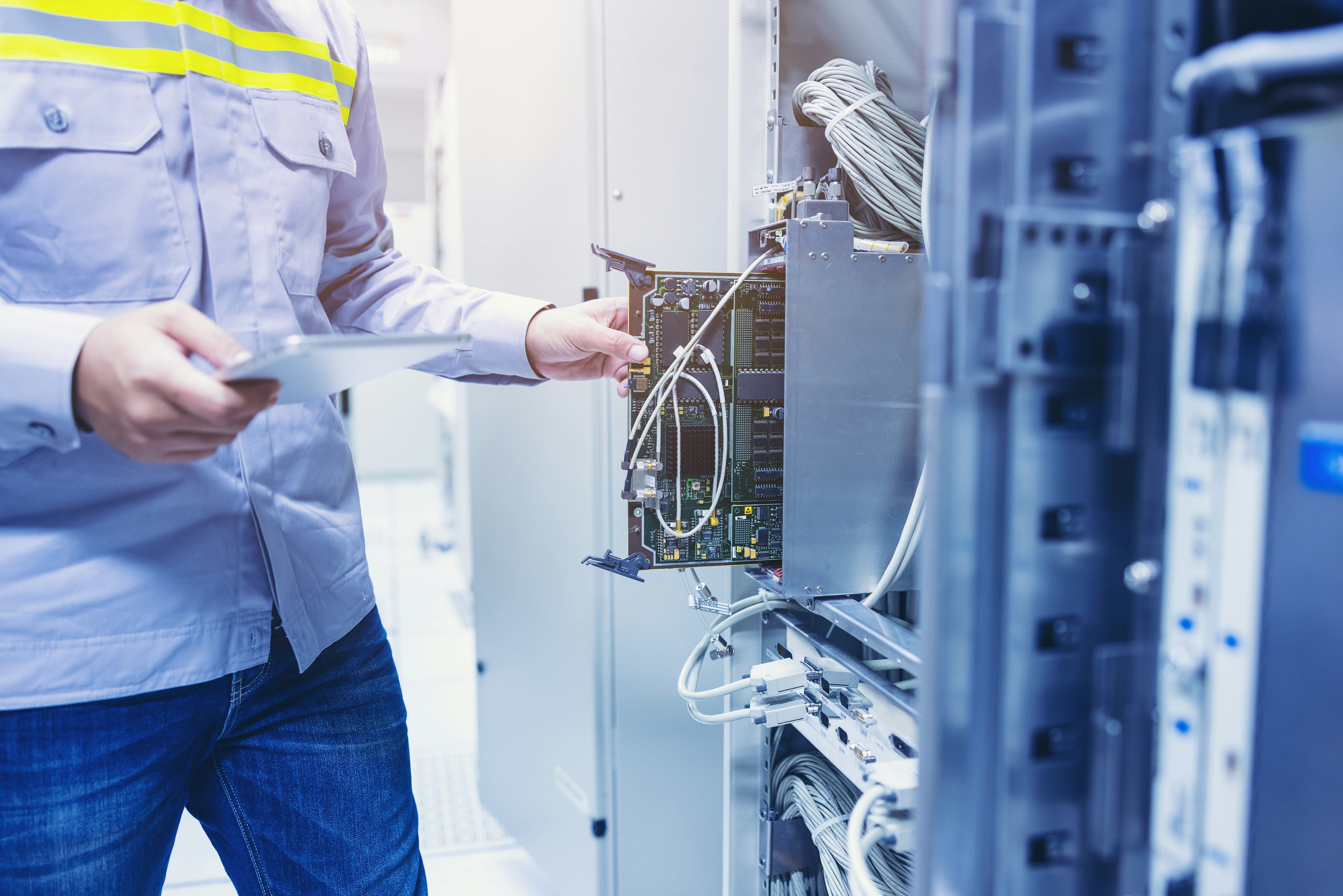 Technician working on cabling in an open server cabinet