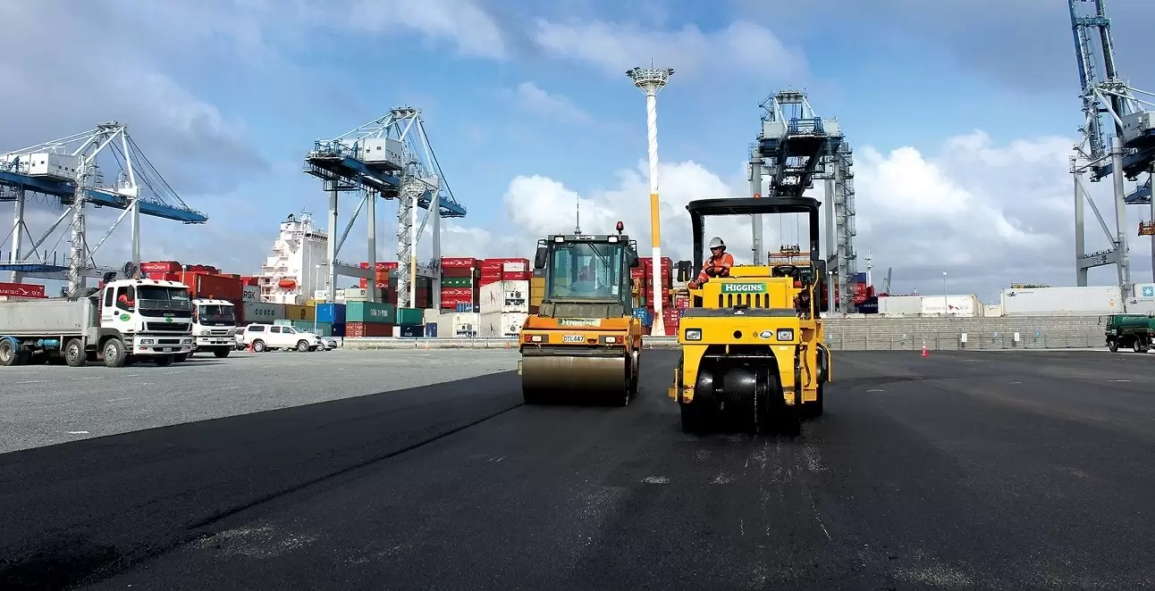 Road rollers paving a container port yard