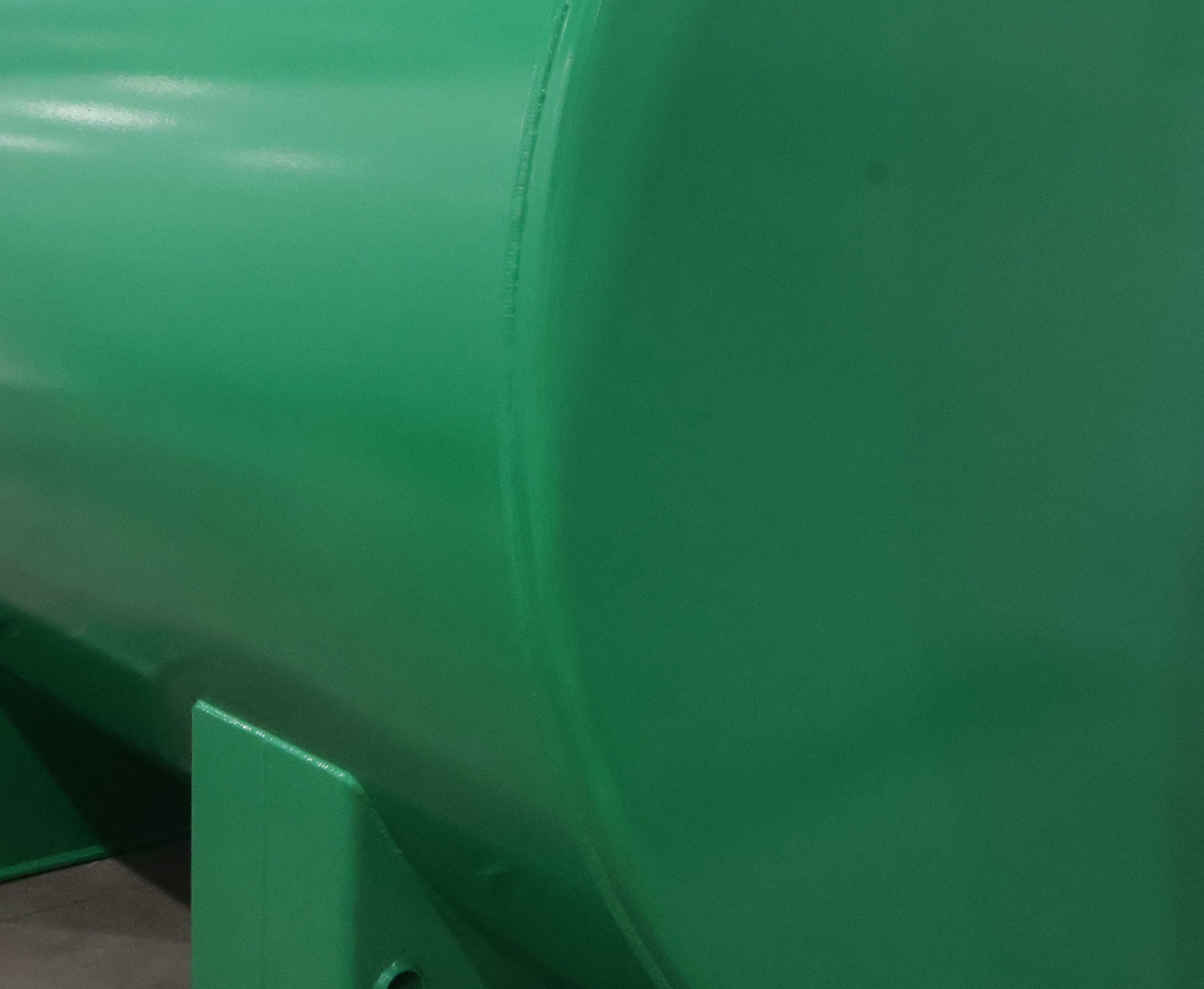 Close view of a green tank shell on its stand