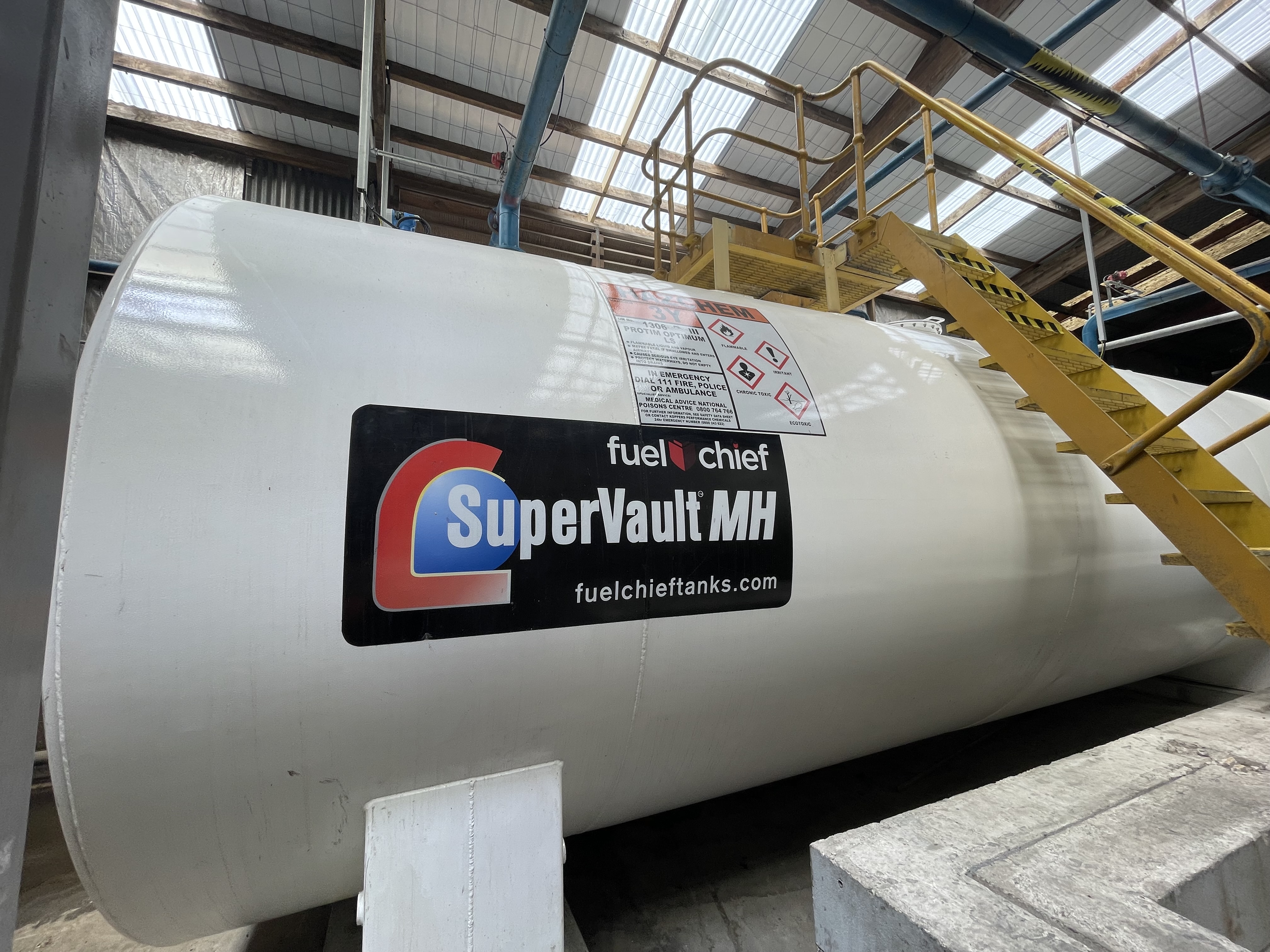 White SuperVault MH tank with yellow stairs in a factory