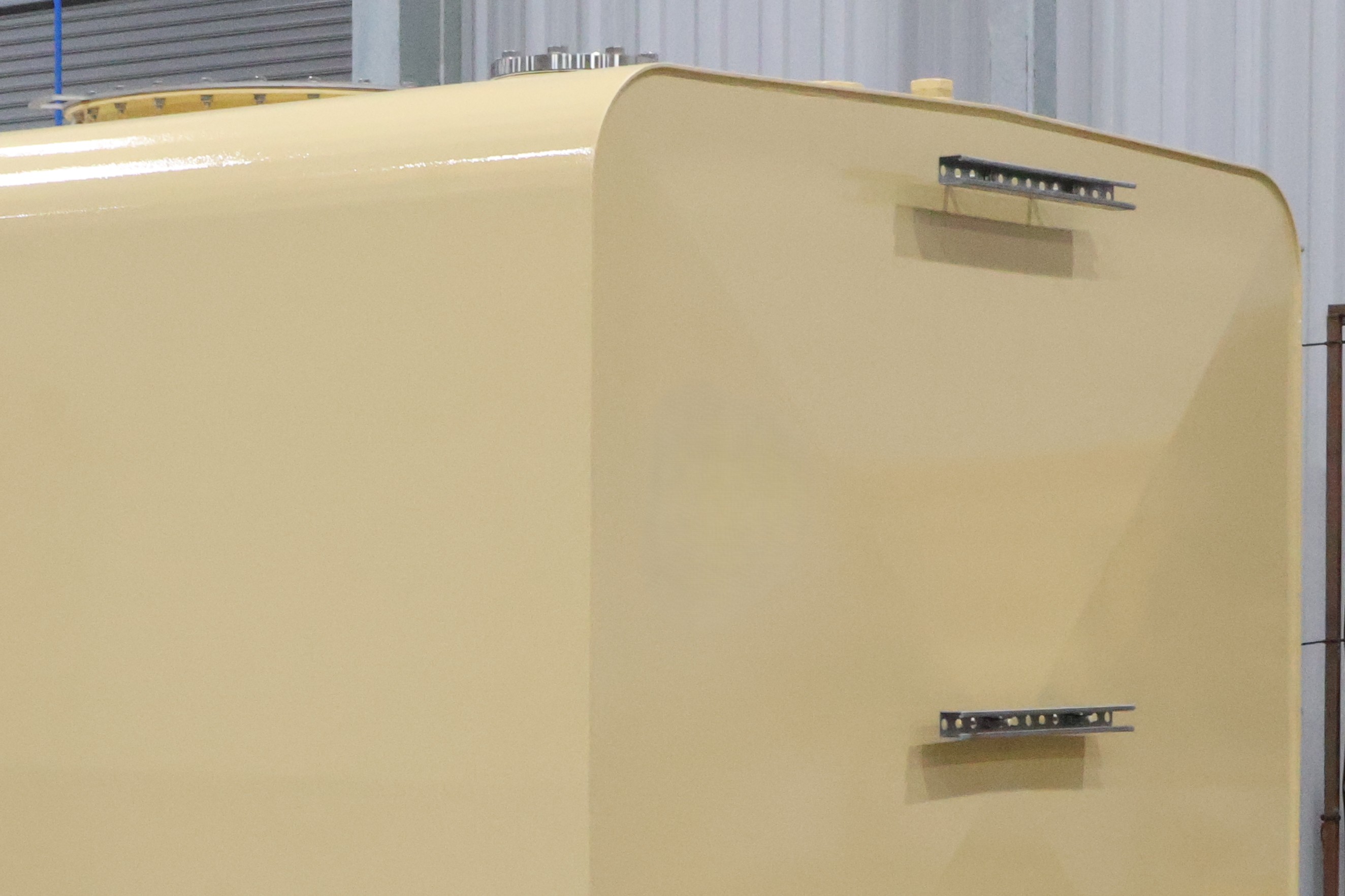 Cream tank shell with two steel brackets